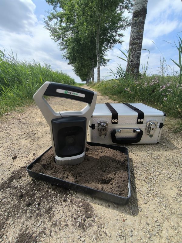 AgroCares Scanner on a soil sample tray in the field